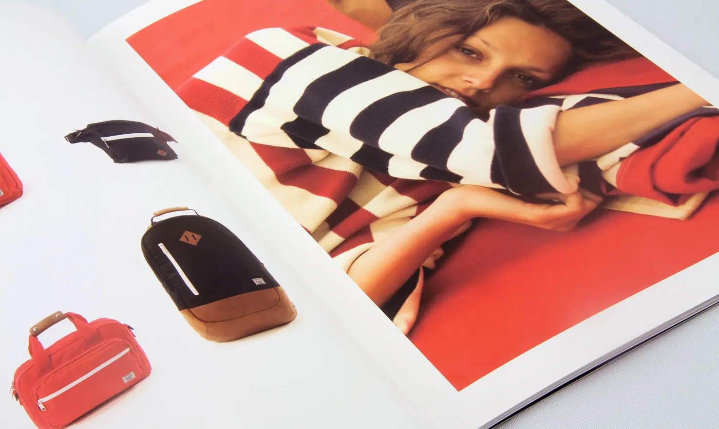 Herschel lookbook spread with red and striped bags