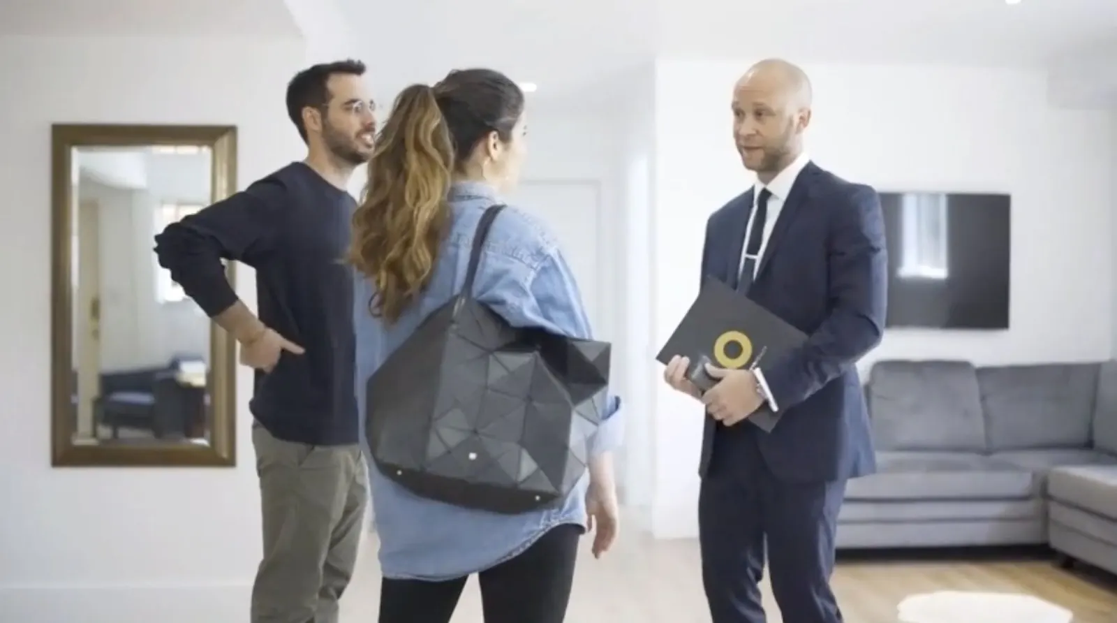 An agent showing a home to a couple