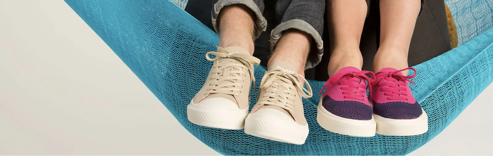 Two pairs of People's Footwear sneakers in a hammock