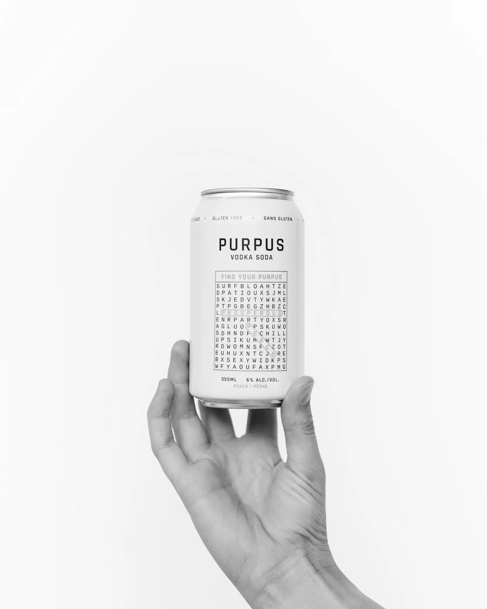 A hand holding a Purpus can