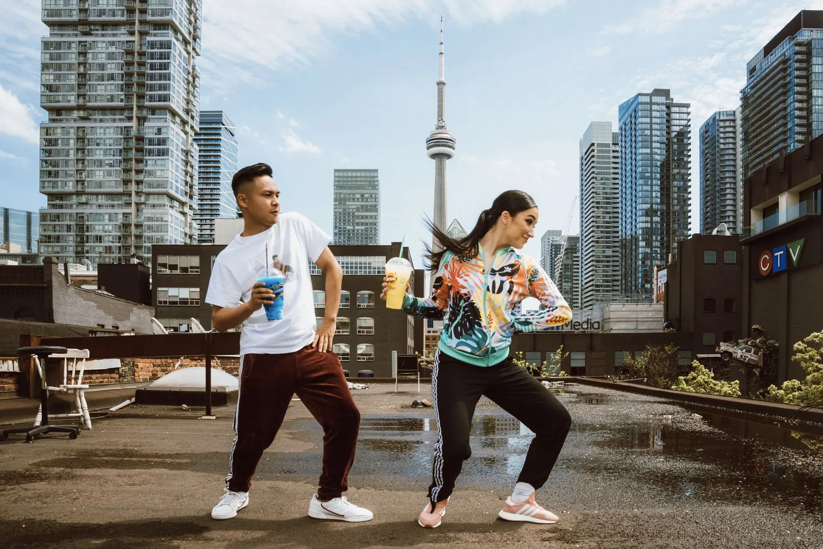 Dancers on a rooftop with the CN Tower behind
