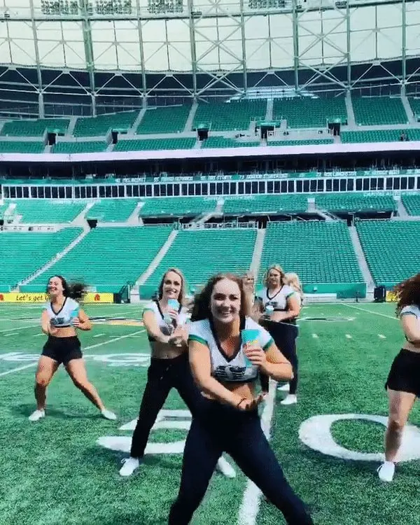 A dance crew performing on a football field